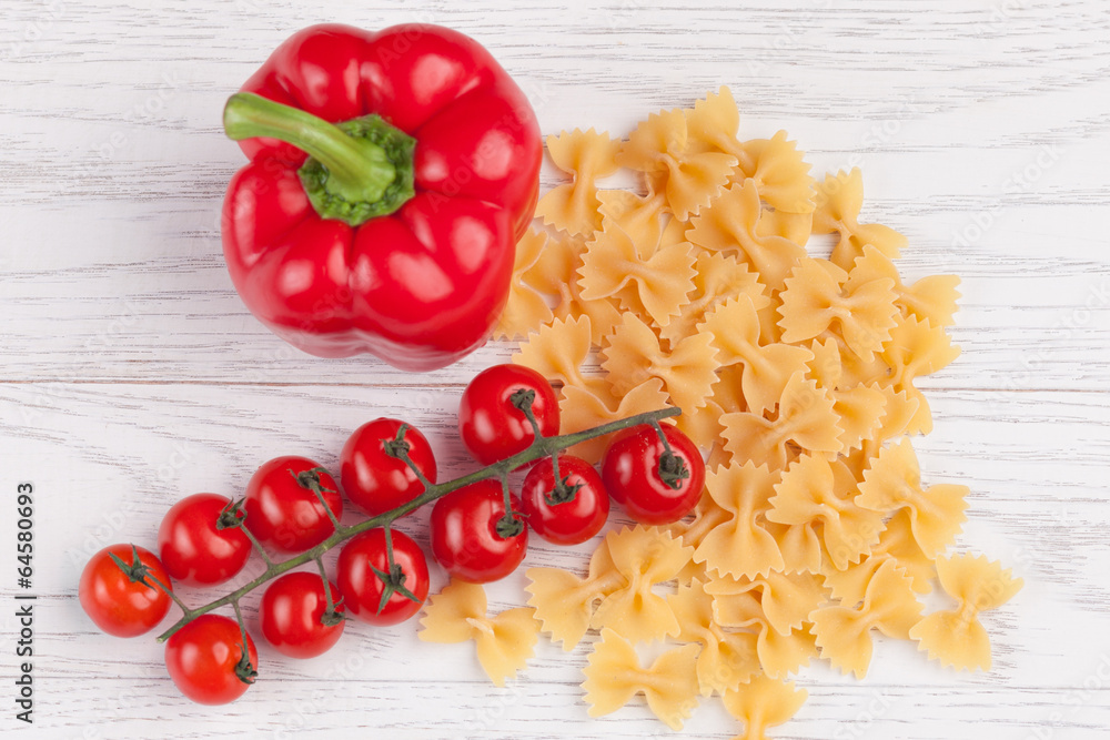 Tomatoes, red pepper and macaroni on table