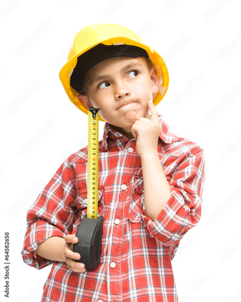 Boy as a construction worker with tape measure Boy as a construction worker with tape measure