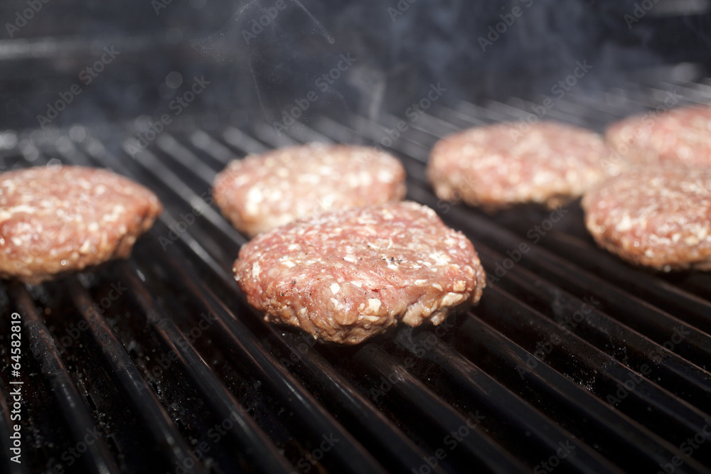 Hamburger patties cooking on a grill Hamburger patties cooking on a grill