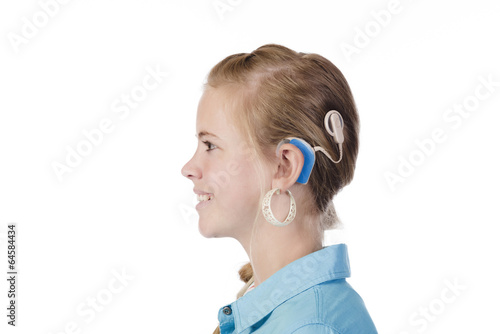 Blond girl with cochlear implant
