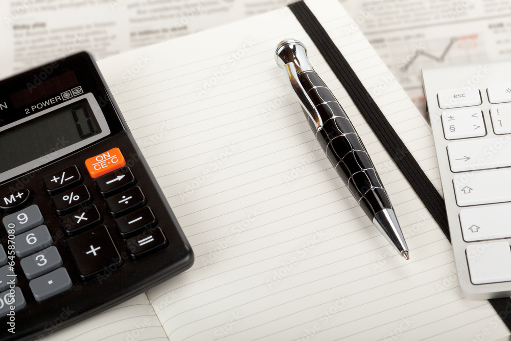 Business newspaper overview with keyboard and calculator. Business newspaper overview with keyboard and calculator.