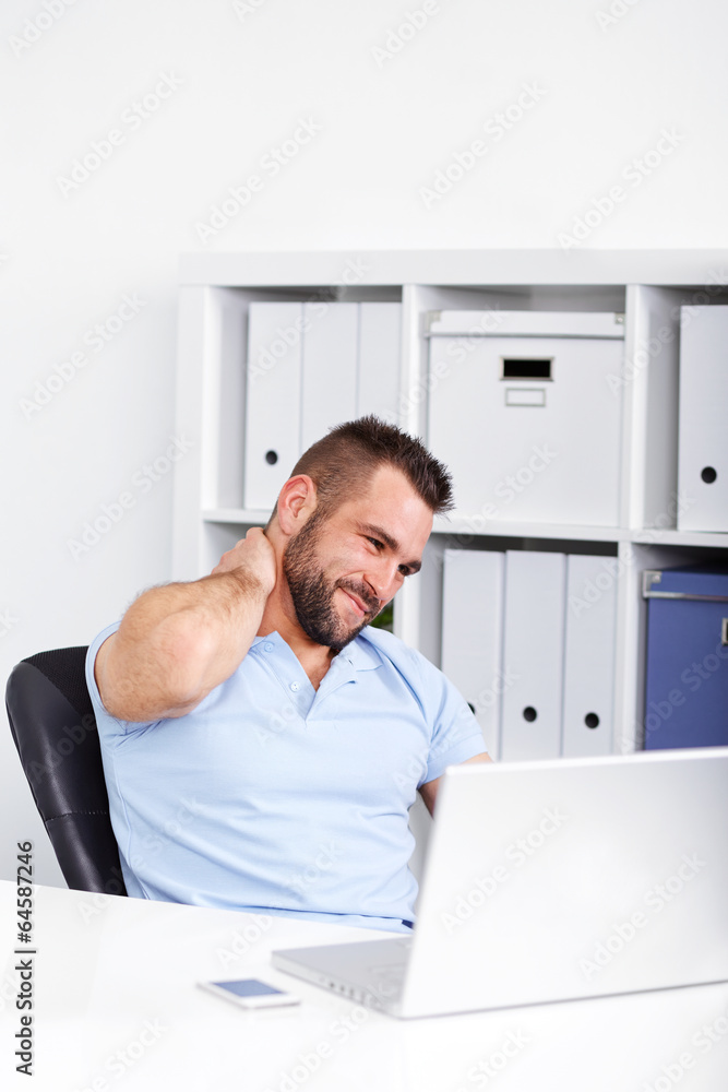 Young businessman has pain of the cervical at work
