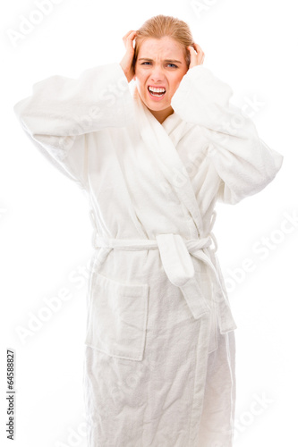 Frustrated young woman standing in bathrobe