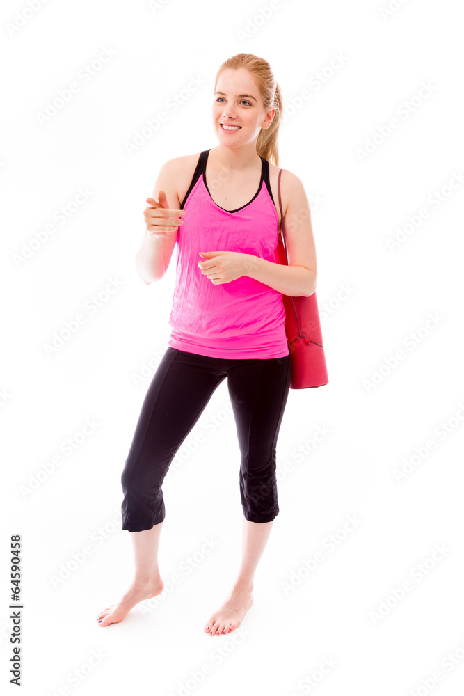 Young woman carrying exercising mat showing something Young woman carrying exercising mat showing something