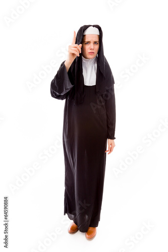 Young nun standing and pointing up