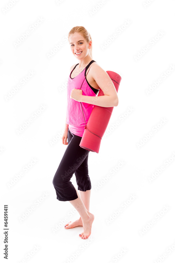Young woman carrying exercise mat smiling Young woman carrying exercise mat smiling