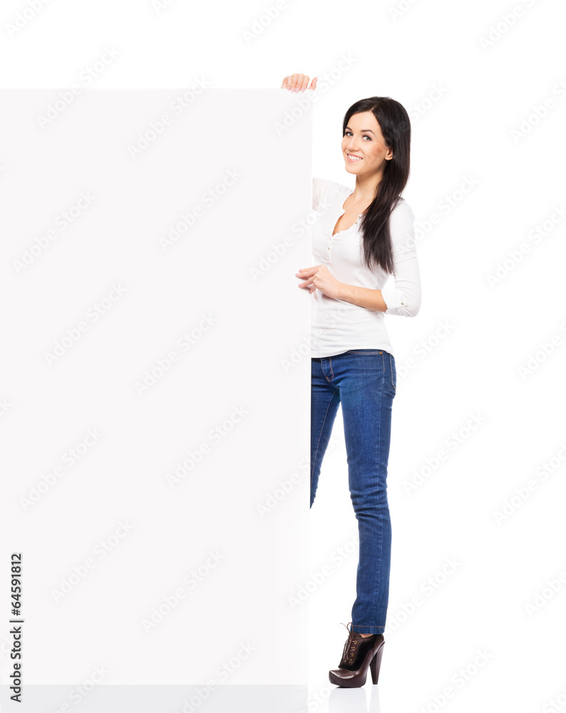Woman in denim jeans holding a blank banner isolated on white Woman in denim jeans holding a blank banner isolated on white