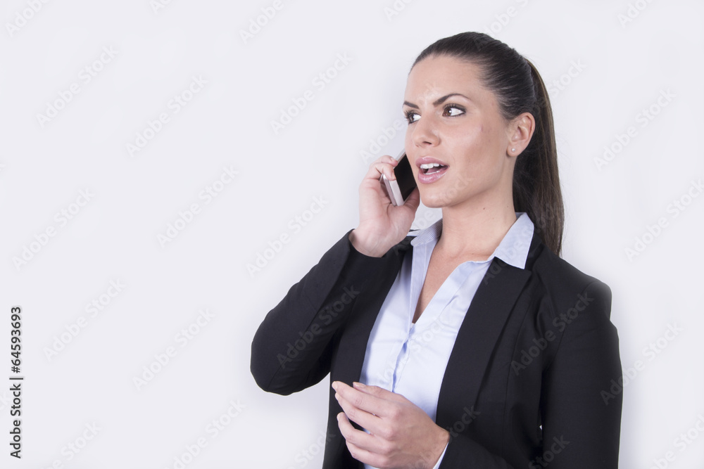 Beautiful business woman talking on her smartphone Beautiful business woman talking on her smartphone