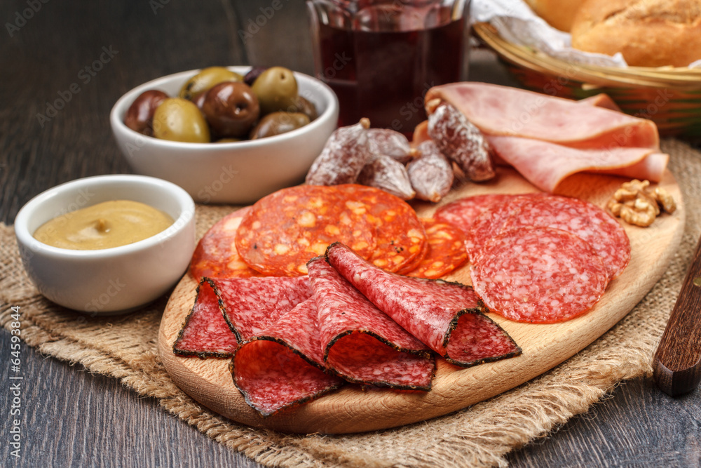 Antipasto with salami, cheese, bread and olives