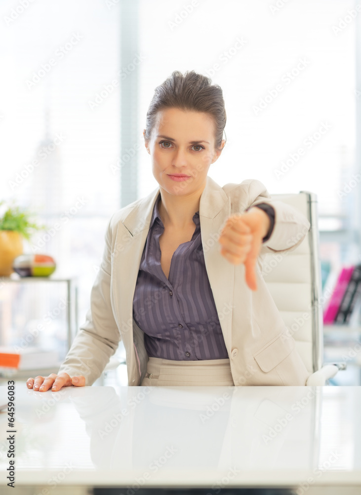 Business woman showing thumbs down Business woman showing thumbs down