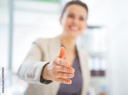 Closeup on happy business woman stretching hand for handshake photo