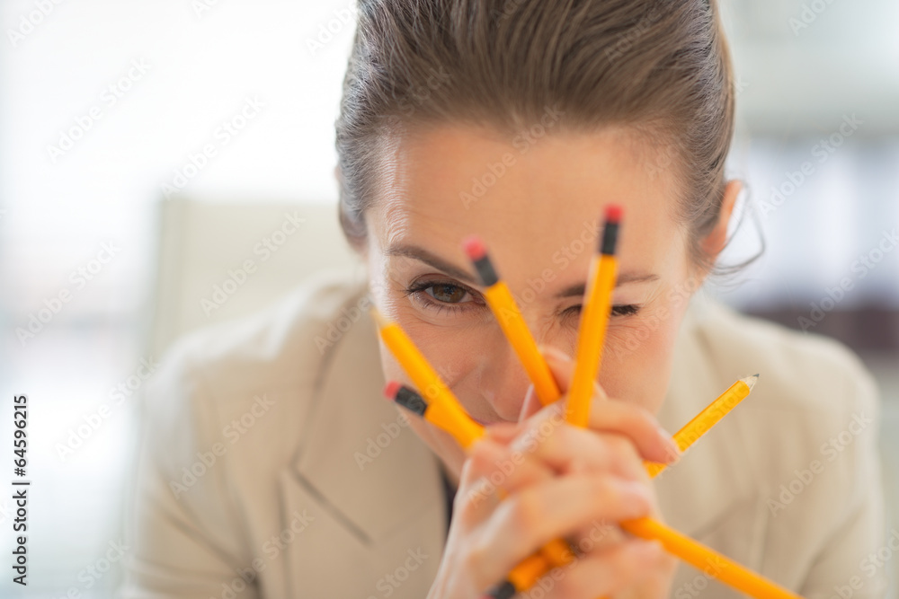 Portrait of business woman holding pencils Portrait of business woman holding pencils