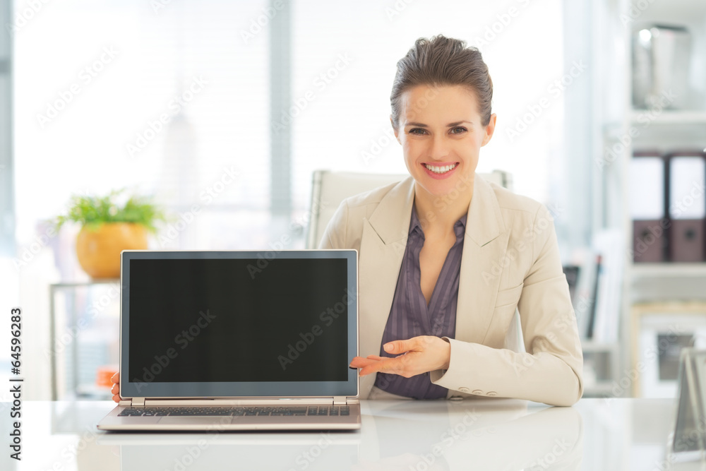 Happy business woman showing laptop blank screen Happy business woman showing laptop blank screen