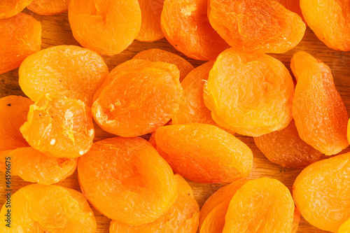 Heap of dried apricots close-up food background