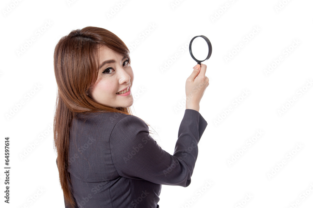 Asian businesswoman use magnifying glass look back to camera Asian businesswoman use magnifying glass look back to camera