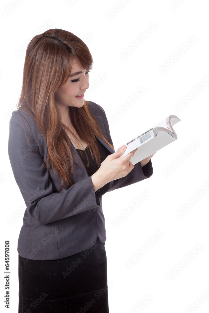 Side view of Asian businesswoman stand reading a book Side view of Asian businesswoman stand reading a book