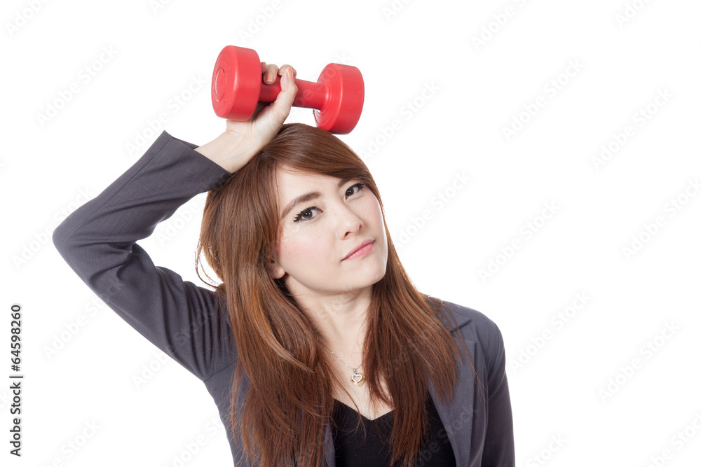 Asian businesswoman hold a drumbbell over her head Asian businesswoman hold a drumbbell over her head