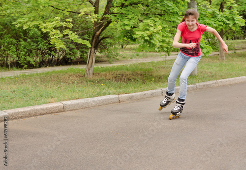 Beautiful young teenage girl roller skating
