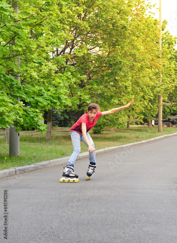 Attractive teenage girl roller skating at speed