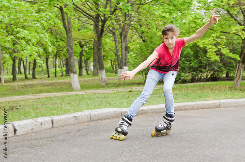 Fototapeta Naklejka Na Ścianę i Meble -  Attractive teenage girl roller skating at speed
