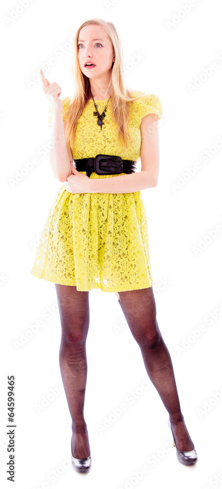 Beautiful young woman pointing upward and looking shocked Beautiful young woman pointing upward and looking shocked