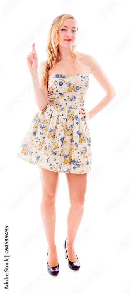 Beautiful young woman standing with her fingers crossed Beautiful young woman standing with her fingers crossed
