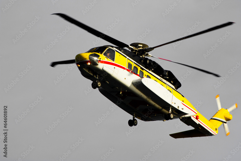 Fototapeta premium A helicopter transporting roughnecks to nearby rigs