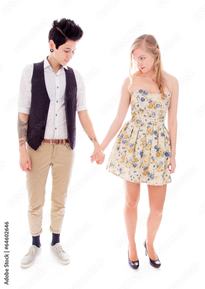 Lesbian couple standing together and holding hands Lesbian couple standing together and holding hands
