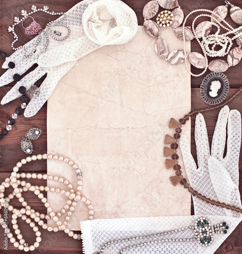 Frame with old women's jewelry and lacy white gloves
