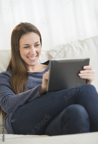 Woman Using Digital Tablet In Living Room