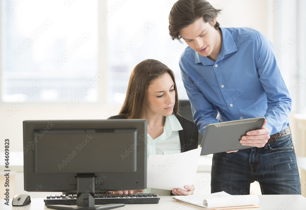 Business People Discussing Over Digital Tablet Business People Discussing Over Digital Tablet