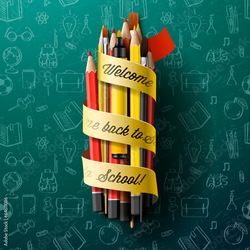 Colorful pencil crayons with text Back to school on ribbon