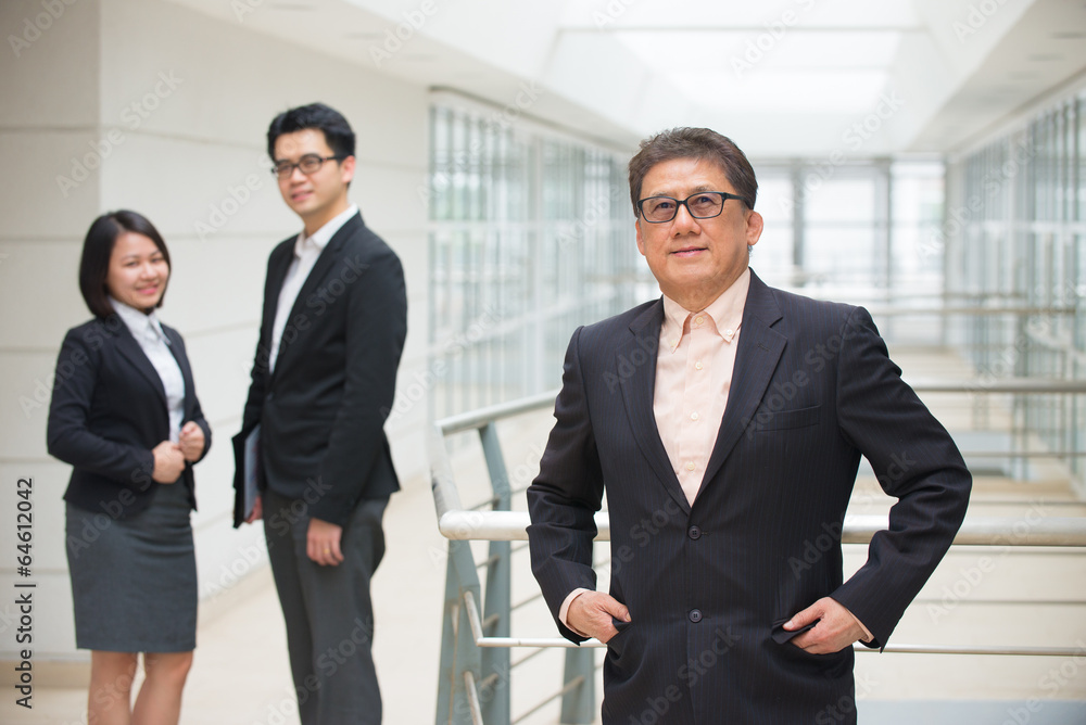 senior asian business ceo with team on background senior asian business ceo with team on background