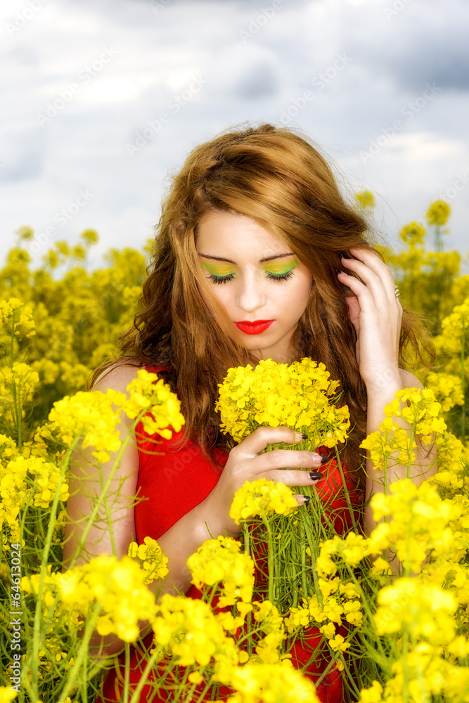 Beautiful young woman in red dress in yellow field Beautiful young woman in red dress in yellow field