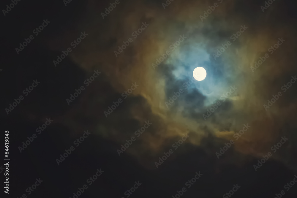 Full moon on dramatic cloudy sky