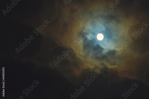 Full moon on dramatic cloudy sky