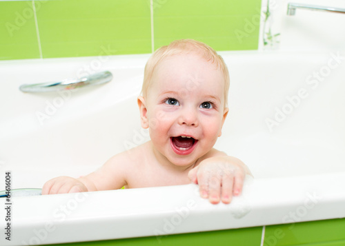 baby boy taking bath and pl...
