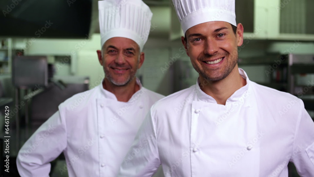 Two smiling chefs giving thumbs up to camera Two smiling chefs giving thumbs up to camera