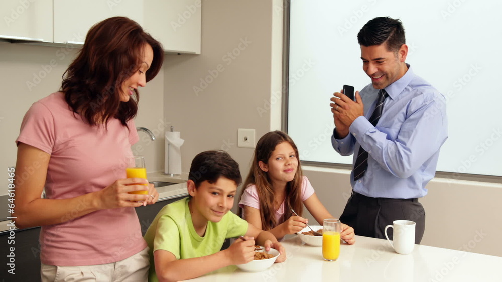Smiling family at breakfast before father goes to work Smiling family at breakfast before father goes to work