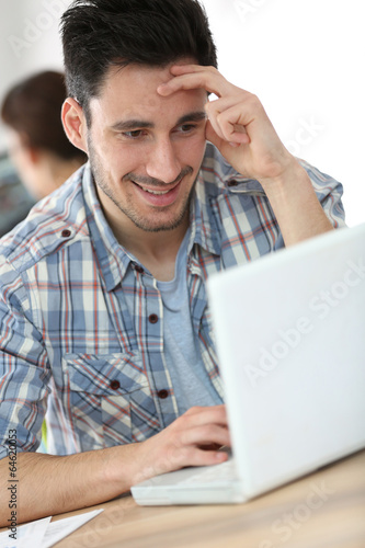 Young man working in office on computer