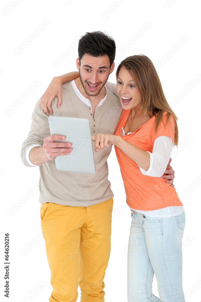 Cheerful couple using digital tablet, isolated Cheerful couple using digital tablet, isolated