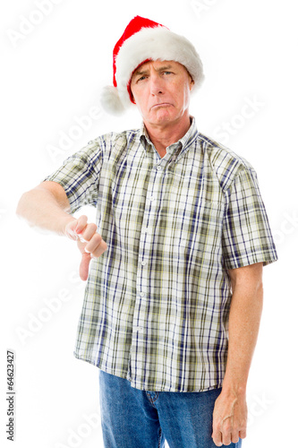 Senior man wearing Santa hat and making thumbs down gesture © bruno135_406