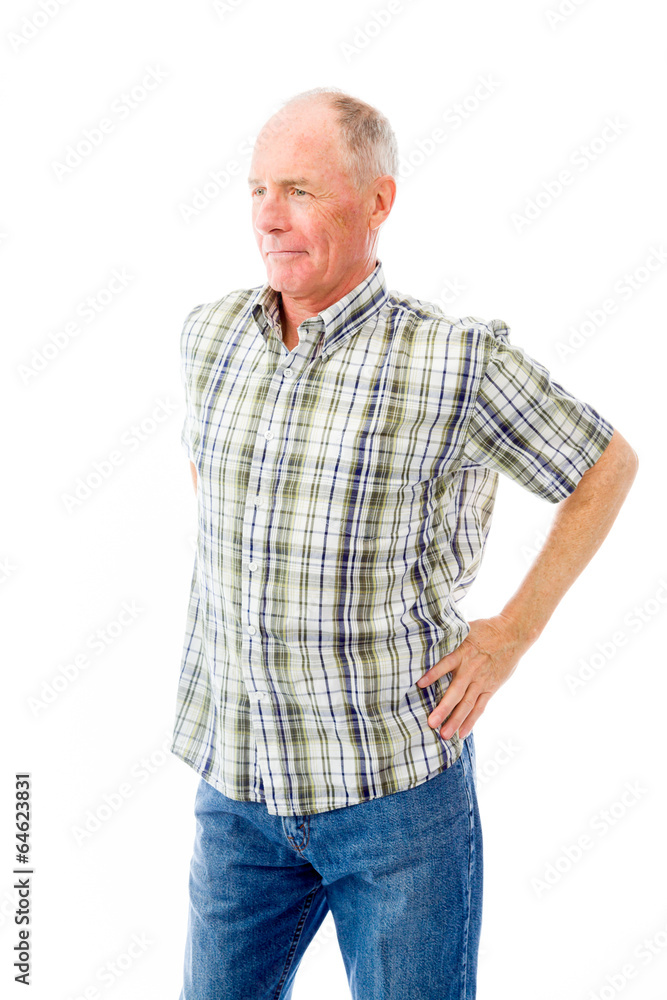 Senior man standing with arms akimbo and thinking Senior man standing with arms akimbo and thinking