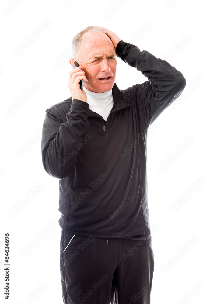 Senior man talking on a mobile phone and looking confused Senior man talking on a mobile phone and looking confused