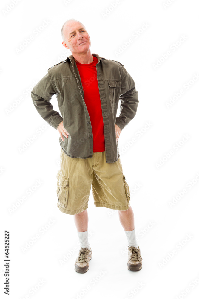 Senior man standing with arms akimbo and thinking Senior man standing with arms akimbo and thinking