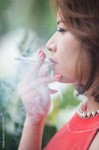 young asian woman smoking cigarette