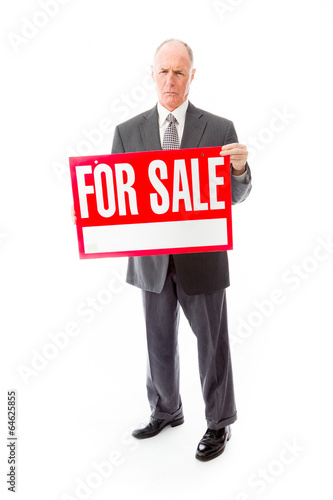 Businessman showing a for sale sign