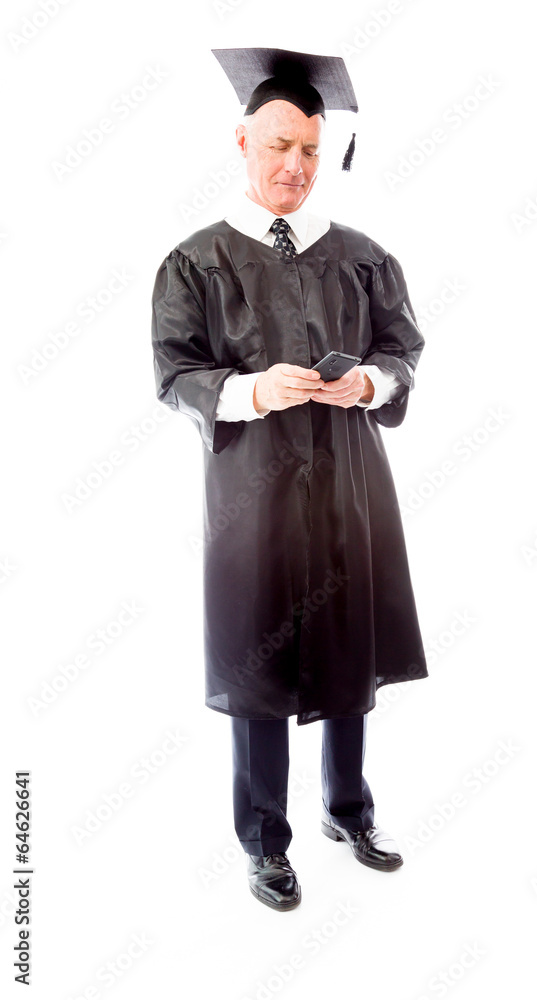 Senior male graduate text messaging on a mobile phone Senior male graduate text messaging on a mobile phone