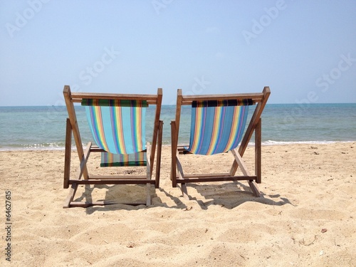 Two lounge chairs on the beach