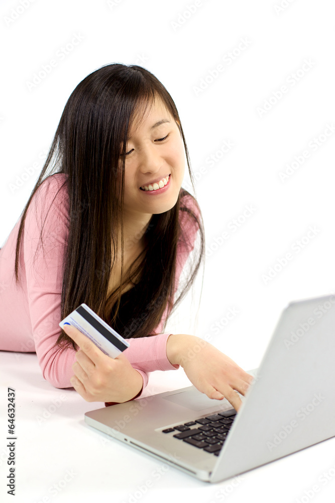 Cute Chinese girl searching to buy online with credit card